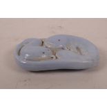 A Chinese blue glazed porcelain scroll weight with dolphin decoration, seal mark to base, 3½" x 2"