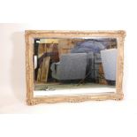 A large gilt framed bevelled glass wall mirror, 50" x 36" overall