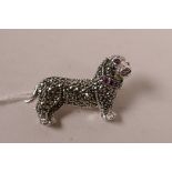 A sterling silver brooch encrusted with marcasite, in the form of a dachshund, 1½" long