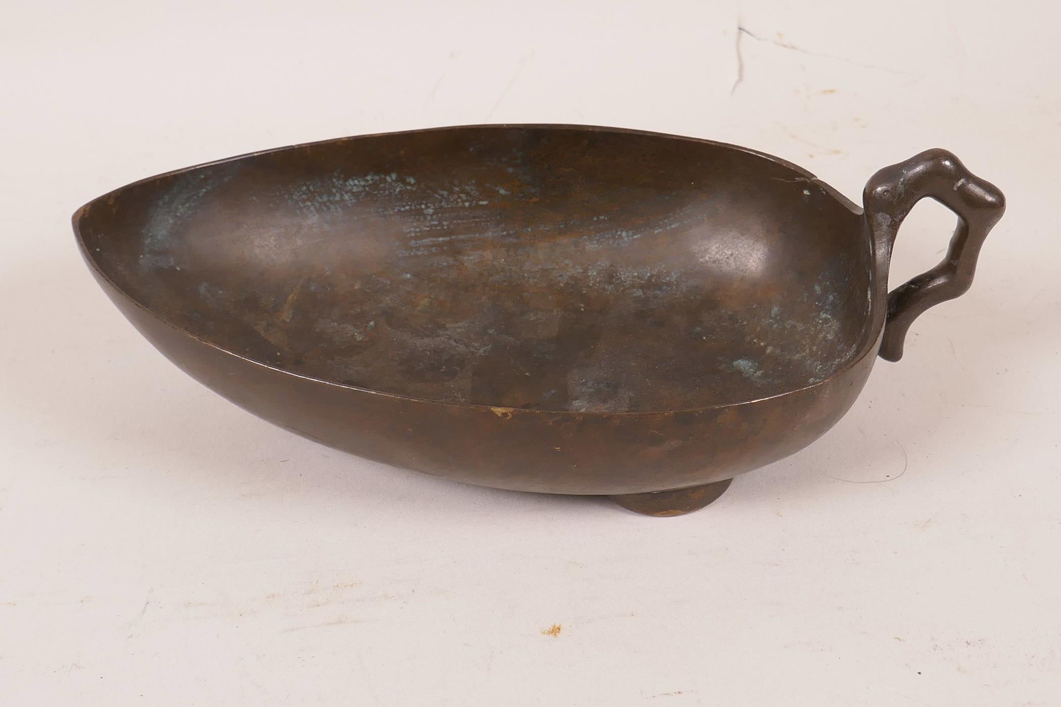 A Chinese bronze leaf shaped pourer, 7½" long