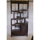 A C19th Chinese hardwood open display cabinet, with carved and pierced decoration depicting birds