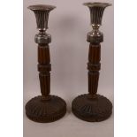 A pair of turned and carved wood and hallmarked silver candlesticks, hallmarked London 1847, maker's
