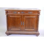 A C19th Italian marble topped commode, with two cupboards flanked by barleytwist columns, opening to
