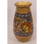 A Charlotte Rhead pottery vase with tubelined floral decoration of a brown glaze, 7" high