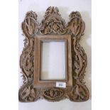 A Chinese wood frame with carved dragon and phoenix decoration, probably early C20th, 16" x 11"