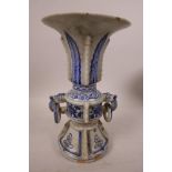 A Chinese blue and white porcelain Gu shaped vase with ring handles and flared rim with leaf and