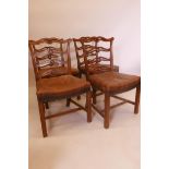 A set of four Chippendale style mahogany pierced ladderback chairs with carved decoration and