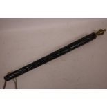 A heavy carved ebony staff with brass finial, 20" long