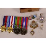 A replica set of WWII medals and ribbons, together with two cap badges and four lapel badges