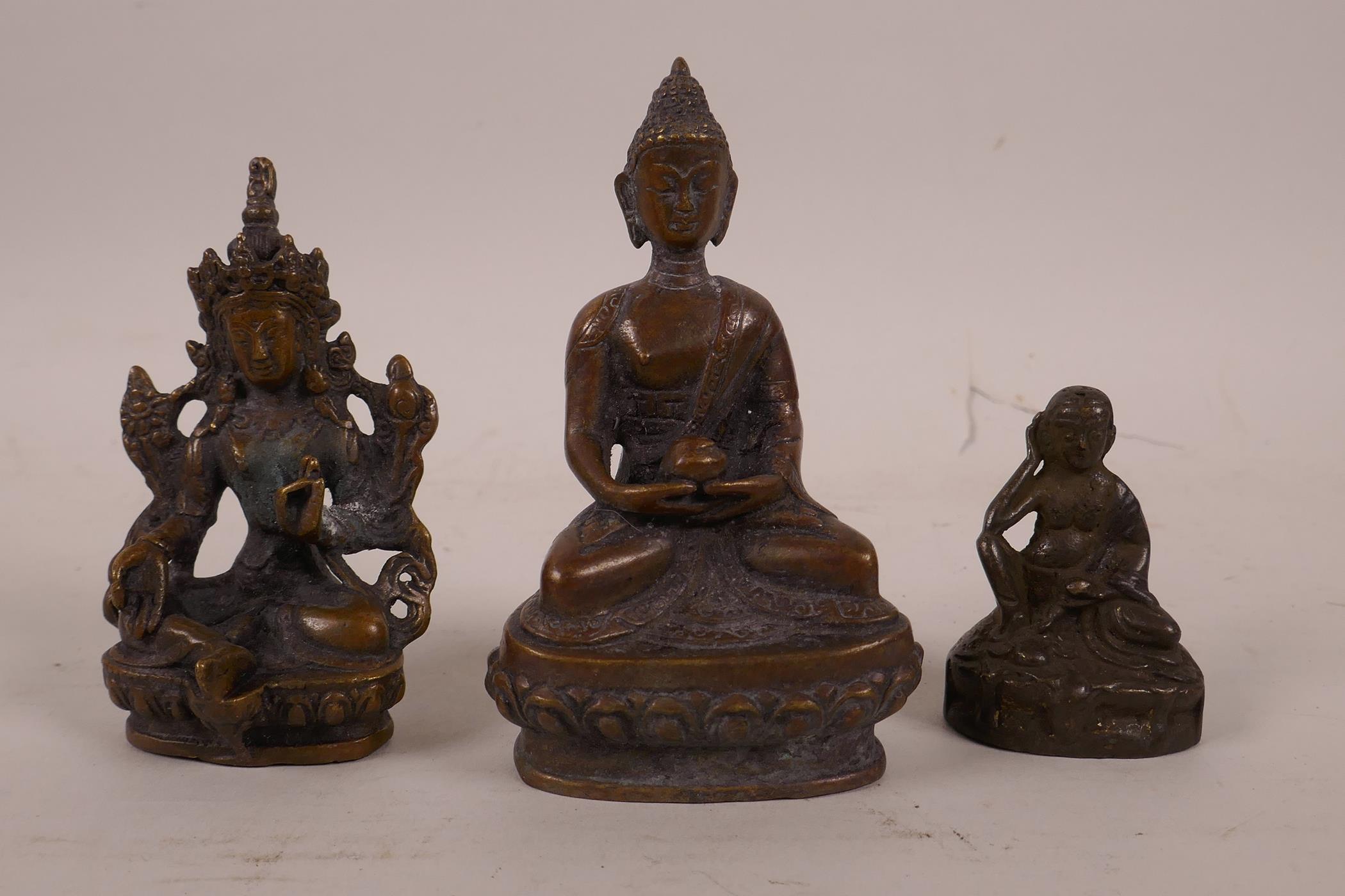 A collection of three small Sino-Tibetan bronze figures of Buddha and other deities, largest 4"