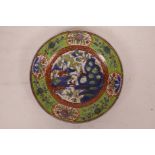 A C19th Chinese clobbered porcelain cabinet plate decorated with a dragon in flight over a riverside