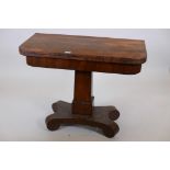 A C19th rosewood card table with fold over top, raised on a square tapering column and scrolled