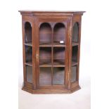 A Dutch oak glazed hanging display cabinet, with canted corners and panelled sides, 32" x 16" x 39"