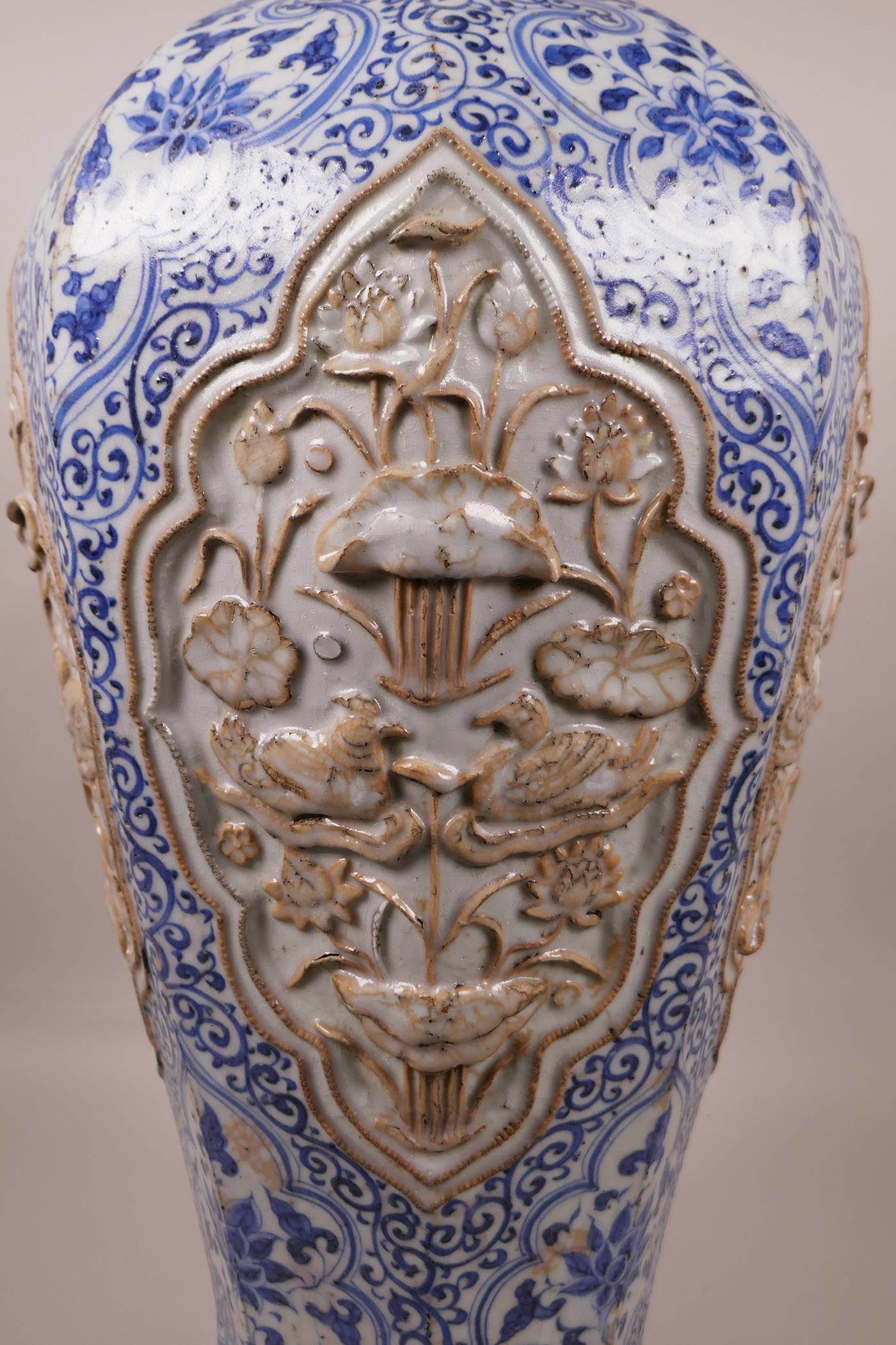 A large Chinese blue and white pottery vase of octagonal form, the panels with raised decoration