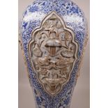 A large Chinese blue and white pottery vase of octagonal form, the panels with raised decoration