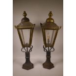 A pair of brass gatepost lanterns with cast iron bases, 30½" high