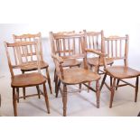 A set of four and one C19th scullery chairs with reeded lathe backs and elm seats, raised on