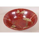 A studio pottery bowl with raised decoration of birds, leaves and flowers, with a metallic finish