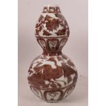 A Chinese porcelain double gourd vase of octagonal form having red/brown glaze of phoenix and