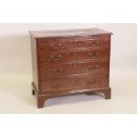 A Georgian mahogany chest of four graduated long drawers and brushing slide, with inlaid top and