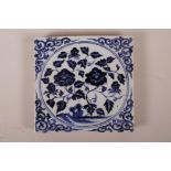 A Chinese blue and white porcelain tile with floral decoration, 8" x 8"