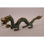 A Chinese painted brass figurine of a dragon, 11½" long