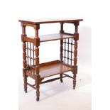A Liberty and Co. Arts and Crafts oak three tier etagere, with lattice sides and turned supports,