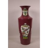 A Chinese raspberry ground porcelain vase decorated with famille verte vases of assorted shapes, 6