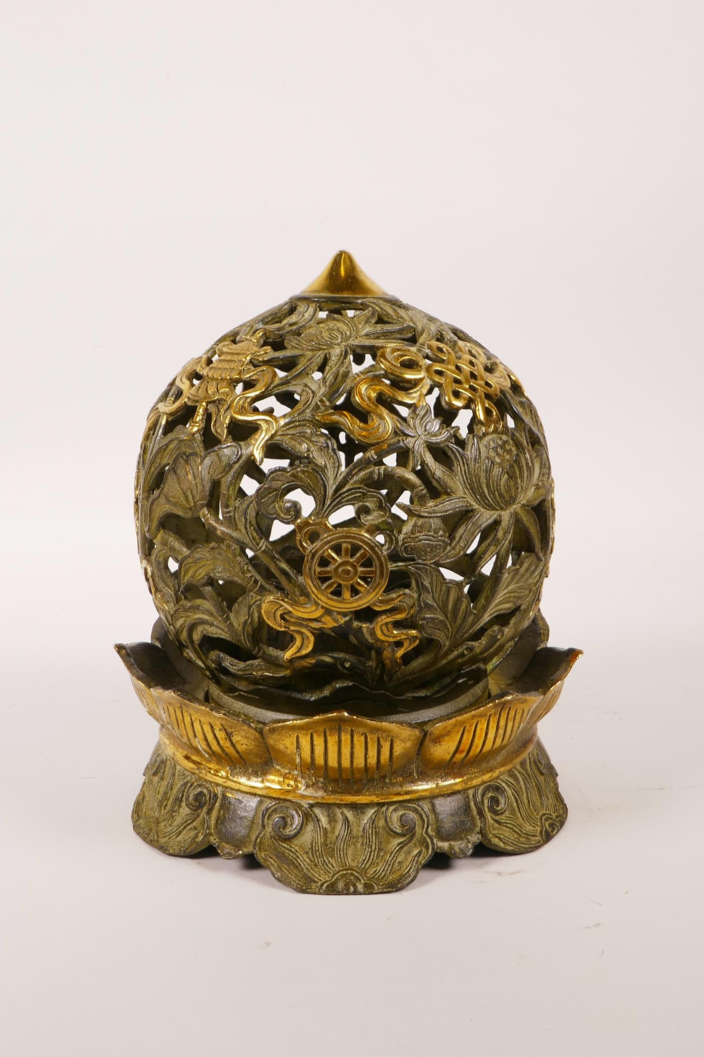 A Chinese pierced bronze ball censer decorated with the eight Buddhist treasures, highlighted with - Image 4 of 4