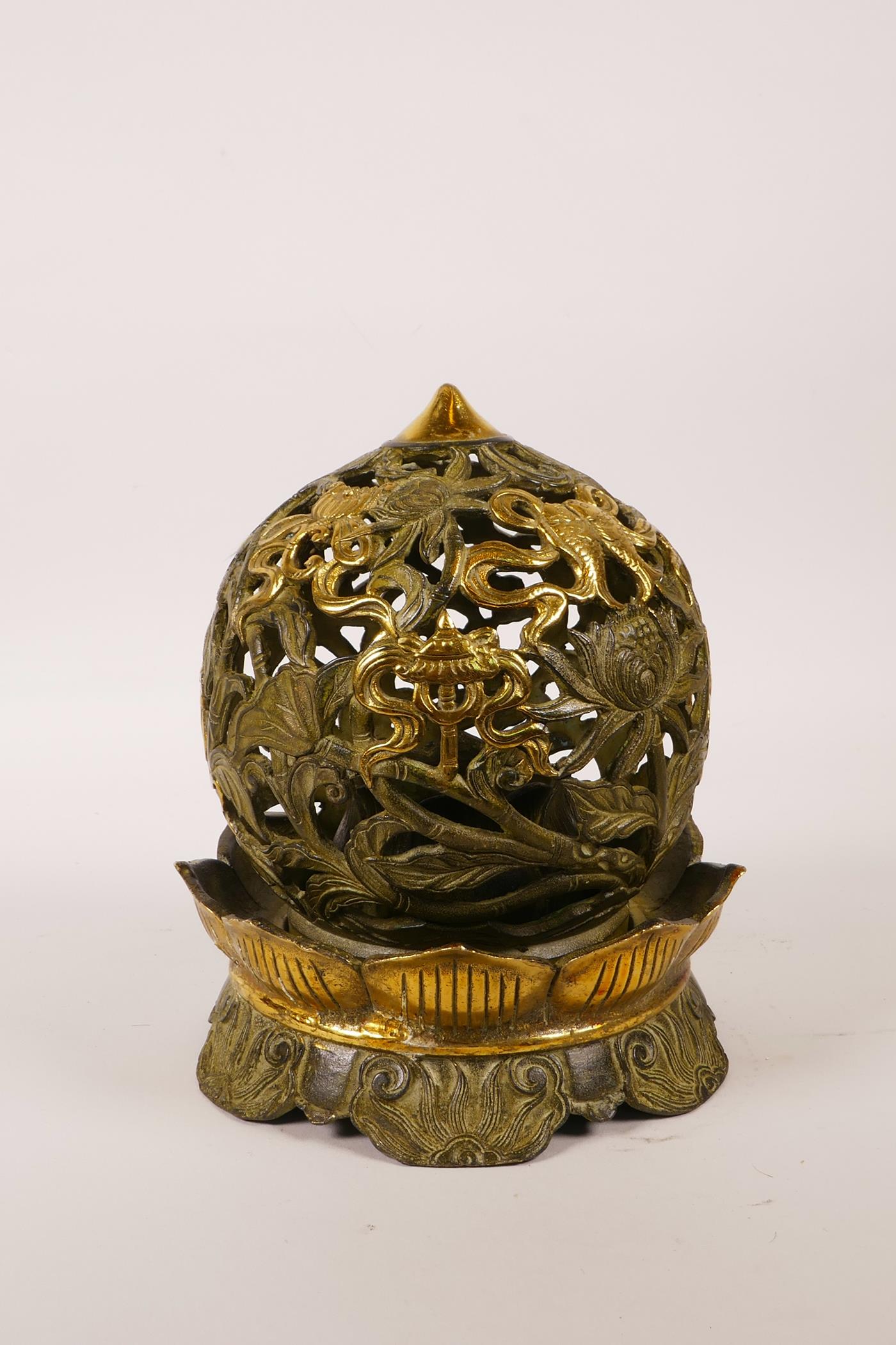 A Chinese pierced bronze ball censer decorated with the eight Buddhist treasures, highlighted with - Image 2 of 4