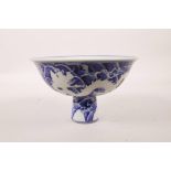 A Chinese blue and white porcelain stem bowl decorated with dragons above waves, 6 character mark to