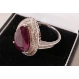 A 14ct white gold and diamond ring set with a pear cut ruby, approx 7.43 carat, diamonds