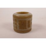 A Chinese celadon jade archers thumb ring with engraved character inscriptions, 1½" diameter