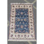 A Kashmiri duck egg blue rug decorated with a Ziegler design to centre and cream ground border,
