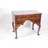 A C18th Irish walnut lowboy, with a long drawer over two, and crossbanded and cockbeaded detail,