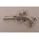 A novelty silver whistle in the form of an C18th pistol, 2½" long
