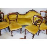 A Victorian walnut carved show wood chaise longue and a set of five Victorian mahogany balloon