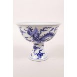 A Chinese blue and white porcelain stem cup decorated with two dragons chasing the flaming pearl,