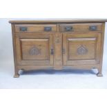 A late C19th oak sideboard with two drawers over two cupboards and fielded panel doors with Oriental