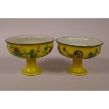 A pair of Chinese yellow ground porcelain stem cups with polychrome decoration of chicken and