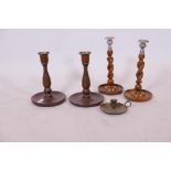 A pair of Arts and Crafts turned oak candlesticks with brass sconces, 10" high, a pair of