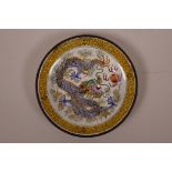 A Chinese Canton enamel saucer decorated with a dragon chasing the flaming pearl, 5¼" diameter