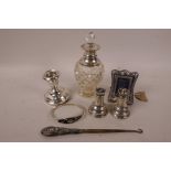A quantity of hallmarked silver items including a small photo frame, candlestick, salt and pepper,