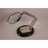 A table magnifying glass on plated articulated frame and wooden base, mirror 5" diameter