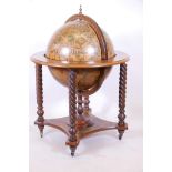 A terrestrial globe cocktail cabinet, with fitted exterior, raised on barleytwist supports, 29" x