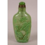 A Chinese green glass snuff bottle decorated with carp and cranes, 3" high