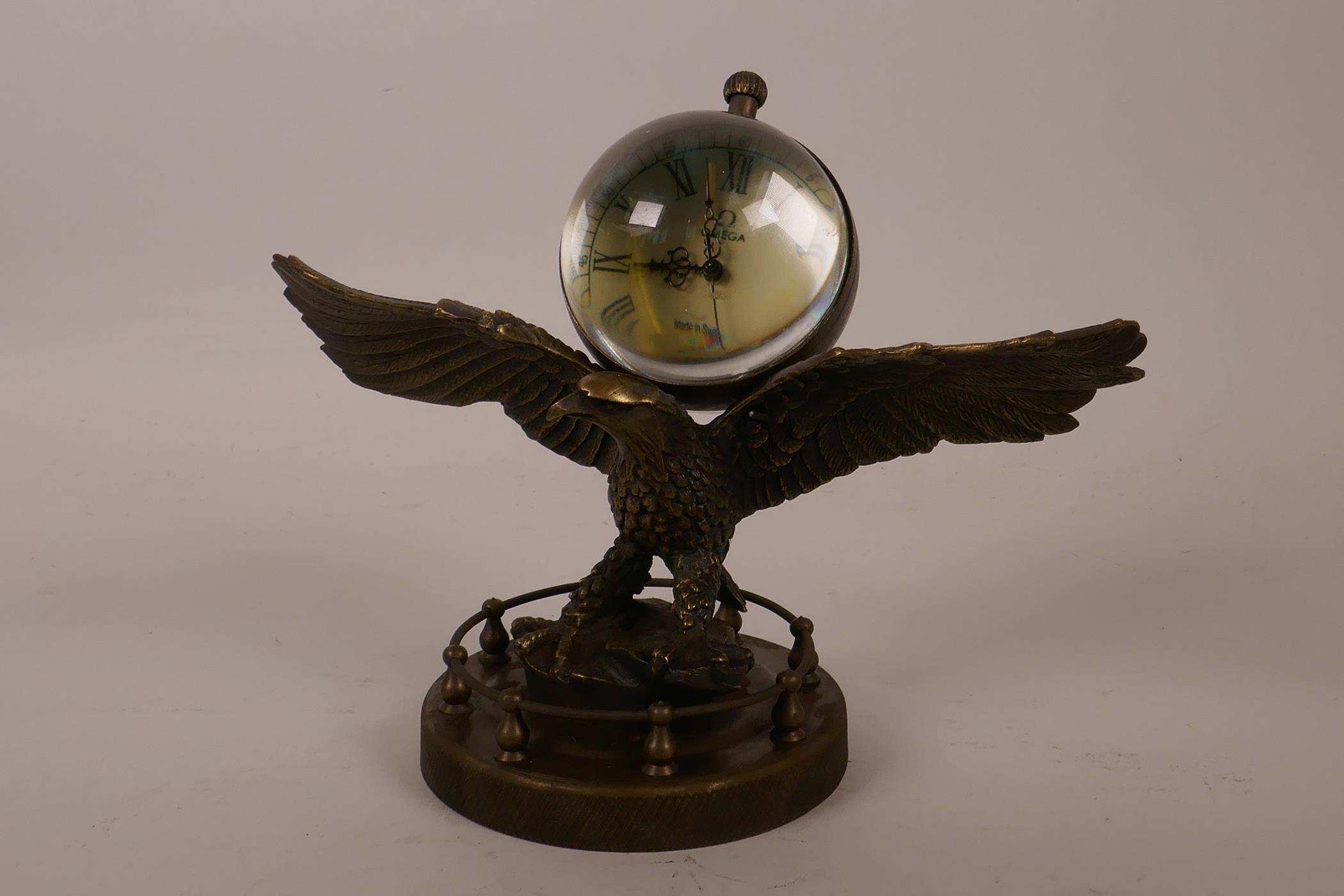 A novelty bronzed metal desk clock in the form of an American eagle with a ball clock on its