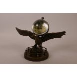 A novelty bronzed metal desk clock in the form of an American eagle with a ball clock on its