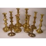 Four pairs of C19th brass ejector candlesticks, tallest 12", and a pair of Queen Anne style brass