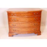 A yew wood bowfronted chest of four graduated drawers, with crossbanded top, canted corners and